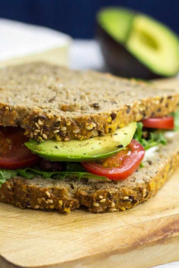 Avocado Sandwich is on the chopping board with a half of avocado | Hurry The Food Up