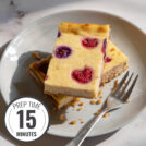 A white plate with two pieces of cottage cheesecake and a fork on the marble surface with a time badge in the bottom left corner | Hurry The Food Up