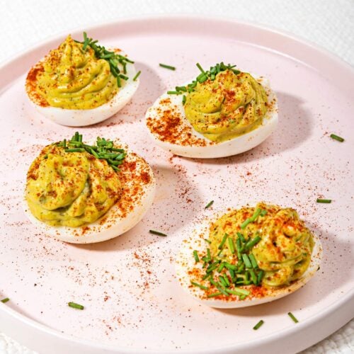 The avocado deviled eggs are served on the white plate that is on the table | Hurry The Food Up