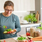 The woman eats salad in the kitchen | Hurry The Food Up