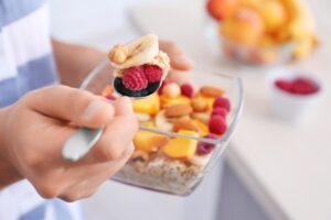 Person eating oatmeal with fruit | Hurry The Food Up