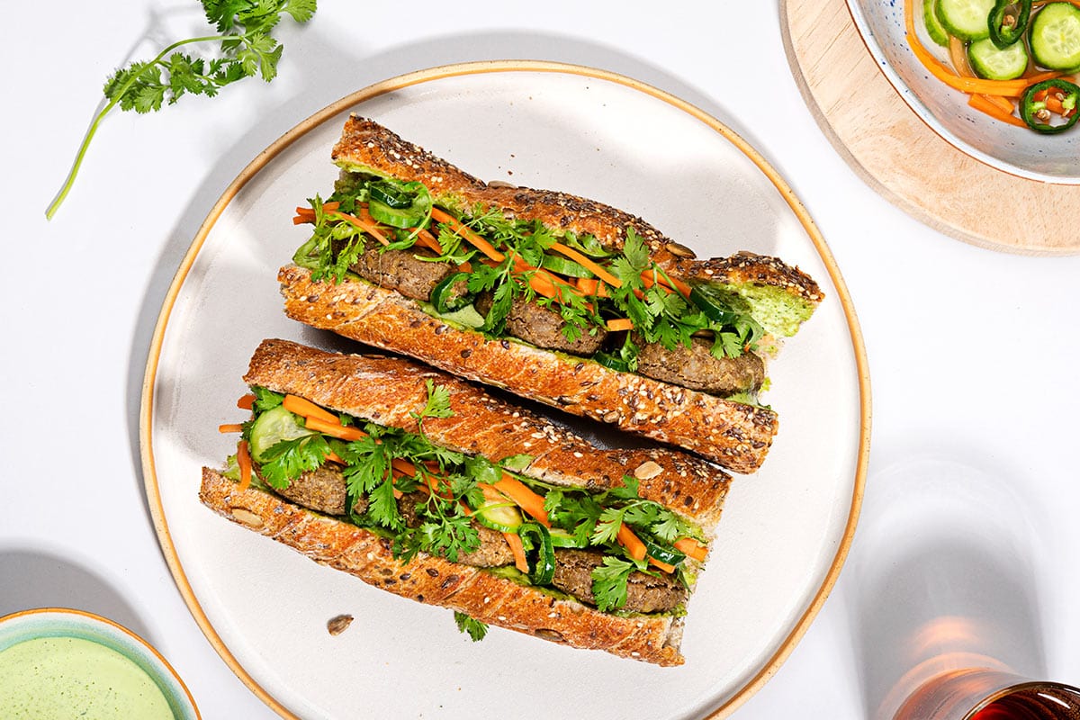 A bird's eye view of two lentil banh mi sandwiches on a plate | Hurry The Food Up