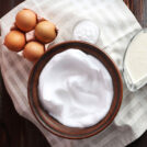 A bowl of whipped egg white, eggs and other ingredients on the tablecloth | Hurry The Food Up