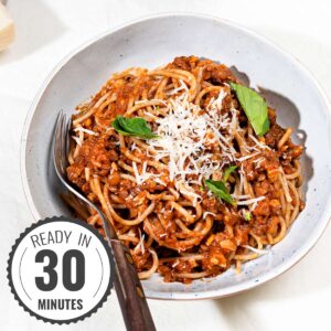 Vegan lentil bolognese served in a bowl with time badge at the left bottom corner | Hurry The Food Up