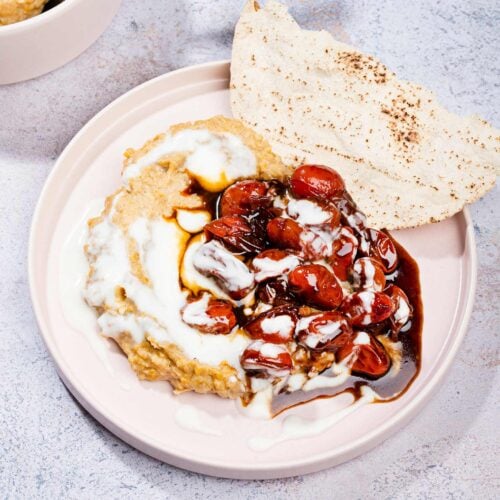 Masabacha dip is served on a plate with cherry tomatoes, low fat yogurt and flatbreads | Hurry The Food Up