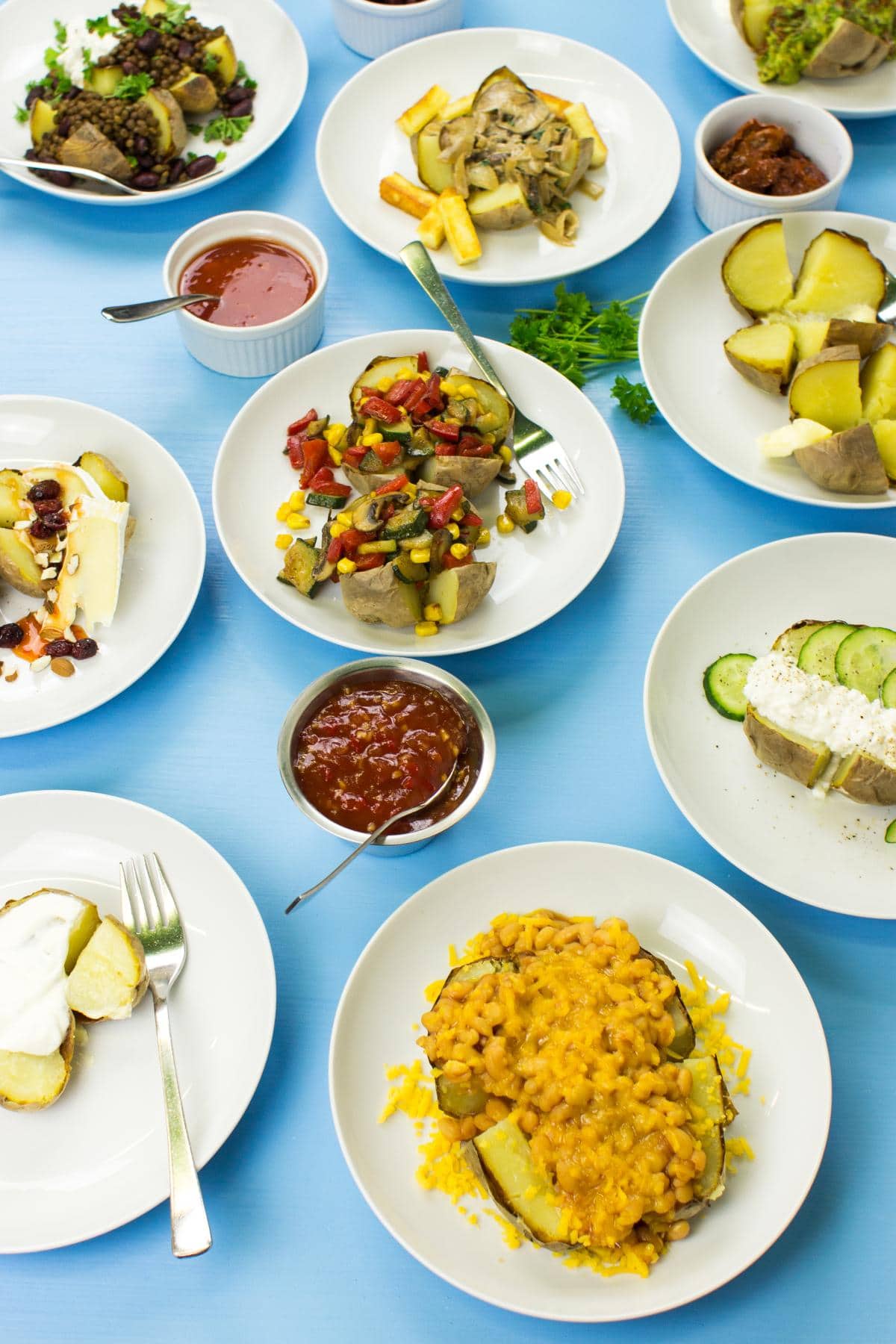 White plates with baked microwave potatoes, which are on the blue surface | HurryTheFoodUp