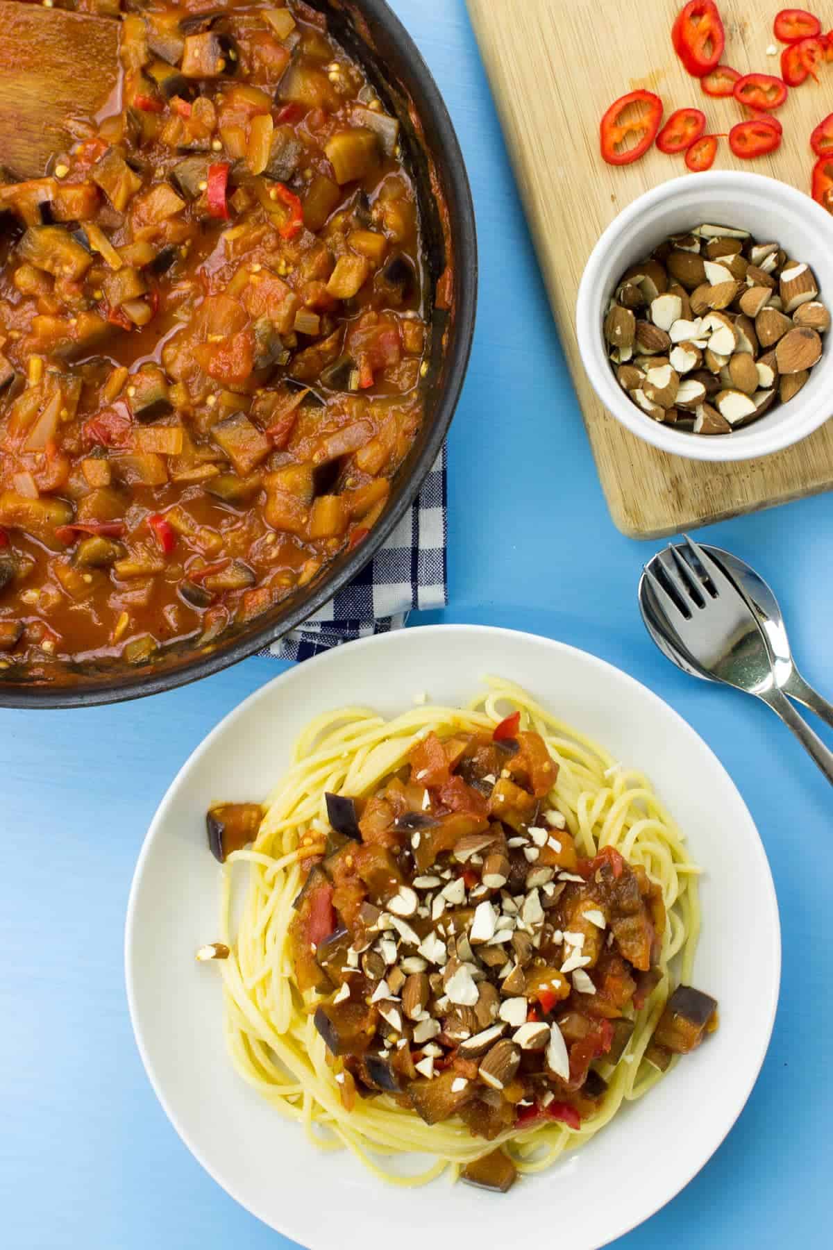 A birds eye view of a plate of spaghetti and arrabbiata sauce & a frying pan full of the extra sauce | Hurry The Food Up