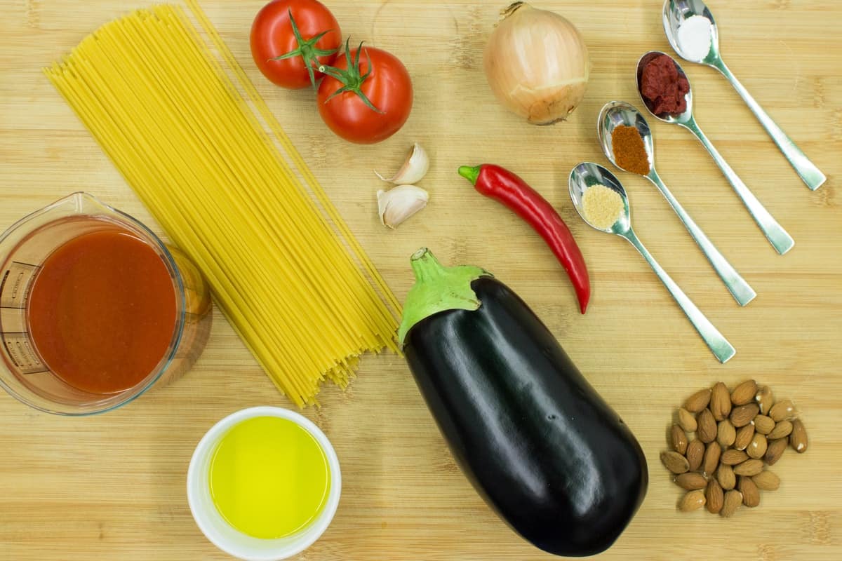 The ingredients for the dish are laid out including spaghetti, tomato, aubergine, tomato juice, oil | Hurry The Food Up