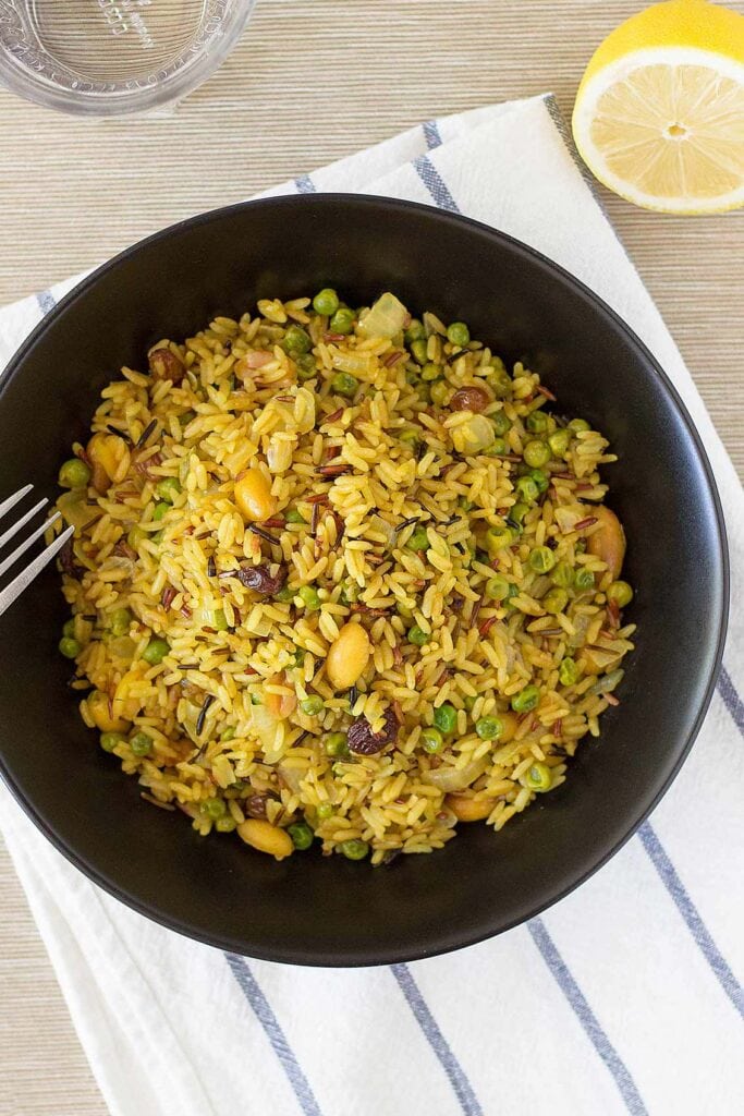 Pea Pulao in the black bowl with fork | Hurry The Food Up