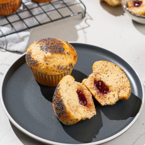 Protein muffins are on the dark plate. Near it there are some whole muffins on a metal grid as well etc | Hurry The Food Up