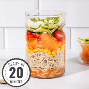 A jar with layers of salad ingredients with a time stamp in the bottom left hand corner | Hurry The Food Up