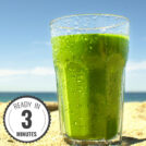 The glass of spinach banana smoothie is on beach | Hurry The Food Up