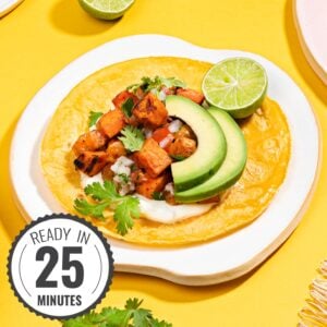 A sweet potato taco is assembled on a plate on a yellow surface with a time stamp at the bottom left corner | Hurry The Food Up