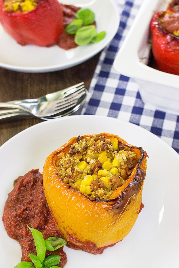 Vegan Stuffed Peppers – Packed with Protein - the stuffed pepper stands on the plate #tempeh #olive oil | hurrythefoodup.com